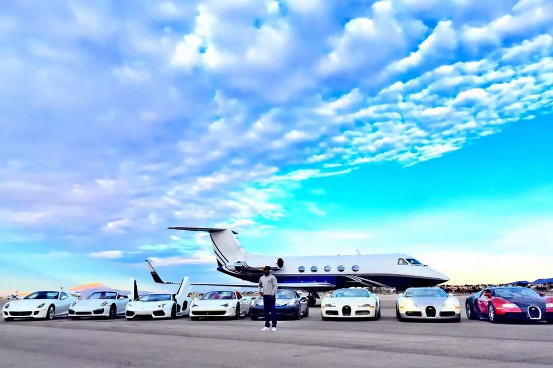 Private jets and cars on an airport ramp