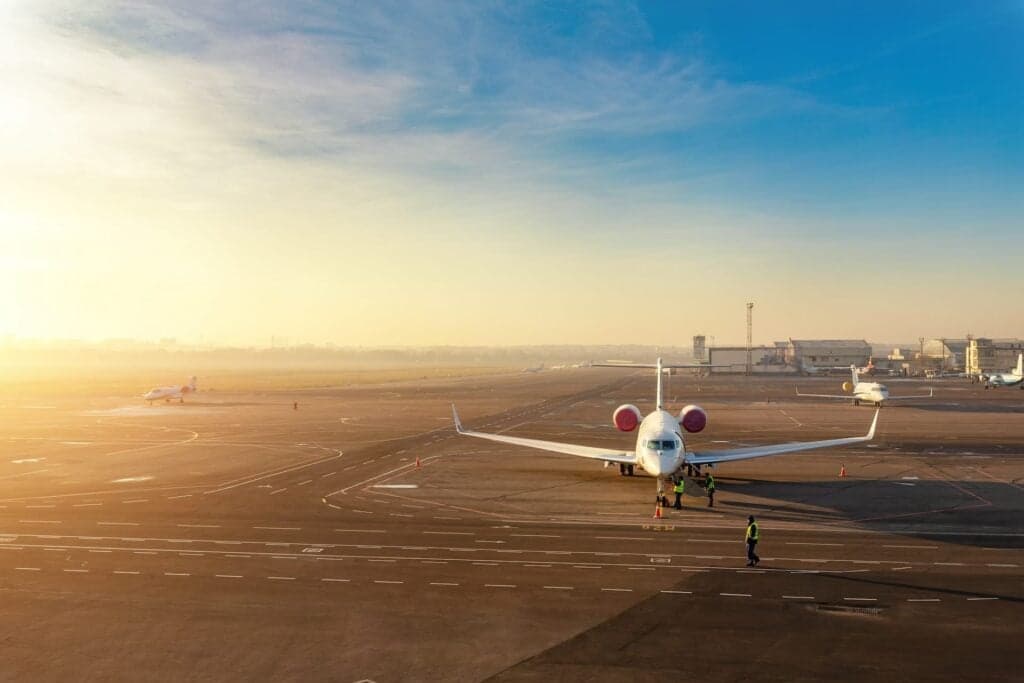 Private jet parked at an airport at sunrise