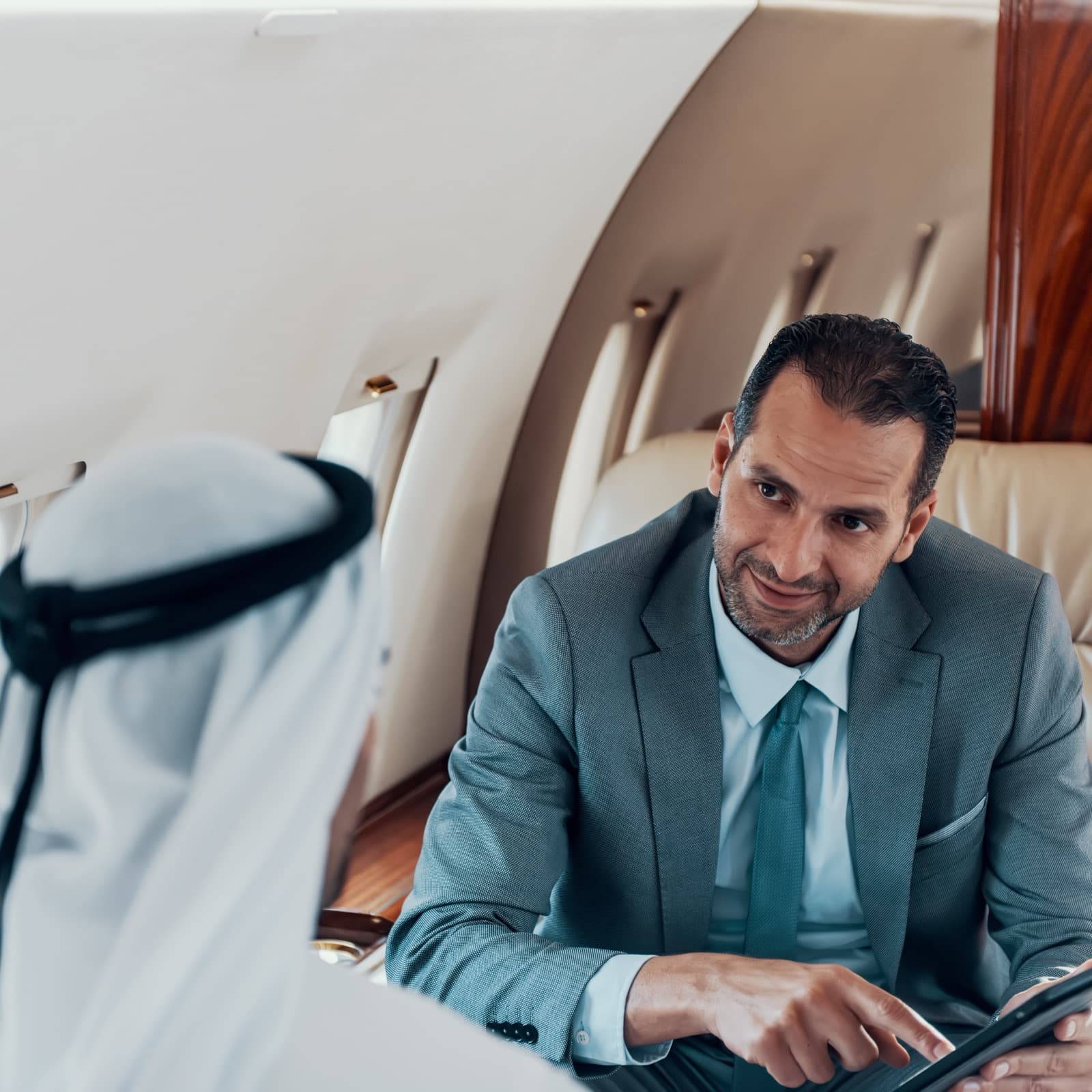 Two people talking inside a private aircraft cabin